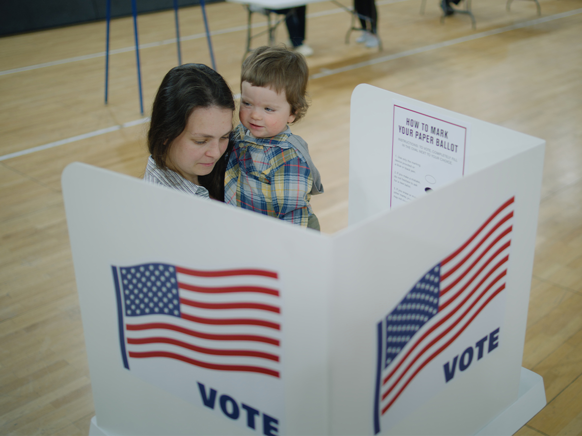 Woman voting with child in her arms