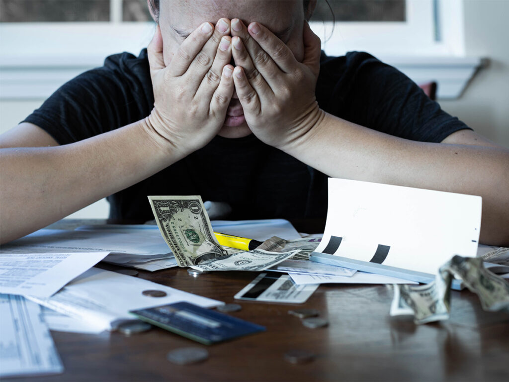 Stressed woman worrying about financial debt and monthly bills.
